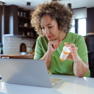 a patient holding a bottle of medication trying to decide what to do. An ADHD doctor in Nashville can help